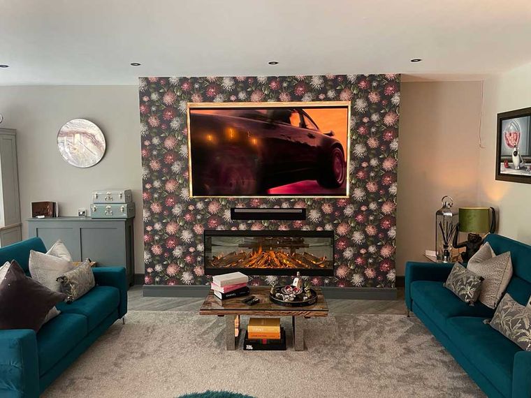 Renovated lounge with a feature media wall and electric fireplace
