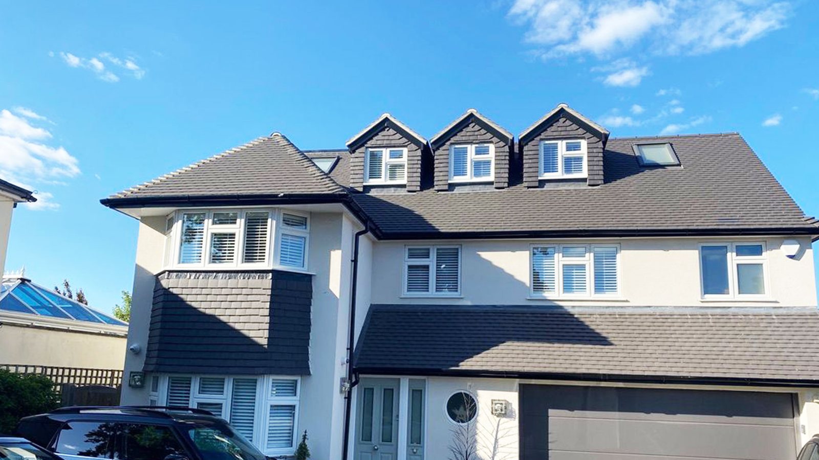 Detached house with three front dormers and a side extension over the garage