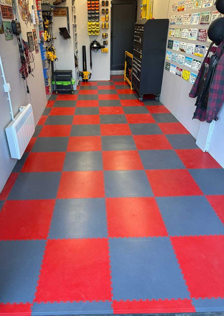 Garage fitted out with an interlocking checkerboard floor and wall storage