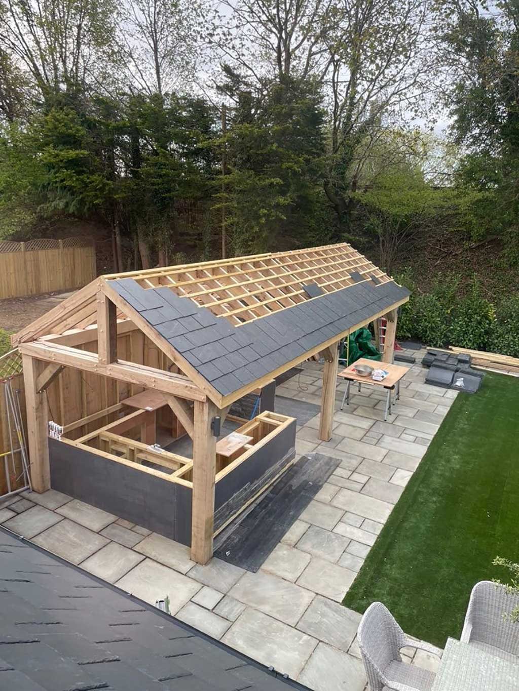 Slate roof being laid on an oak framed garden building