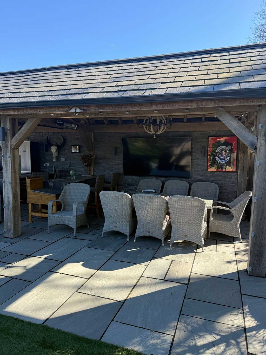 Covered outdoor dining area under an oak framed garden building
